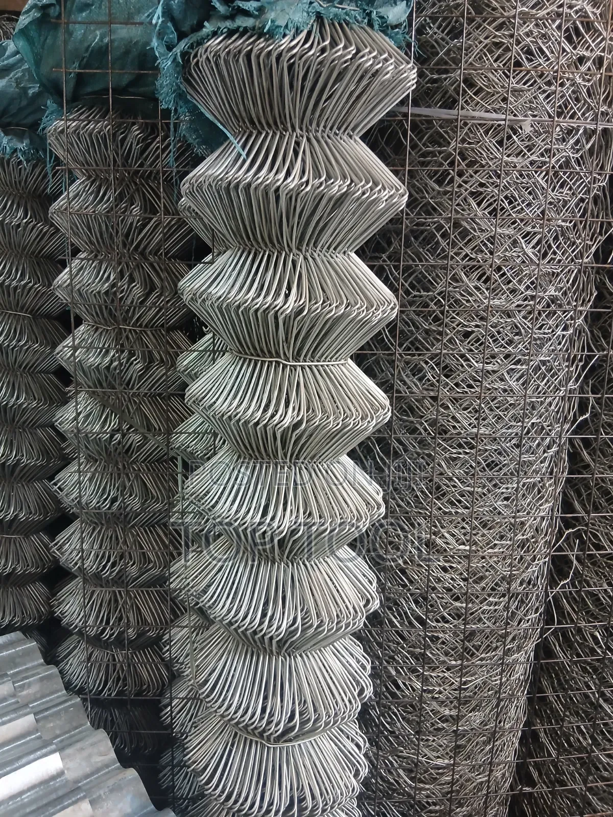 ,Appears to Be a Roll of Galvanized Steel Chain-Link Fencing.