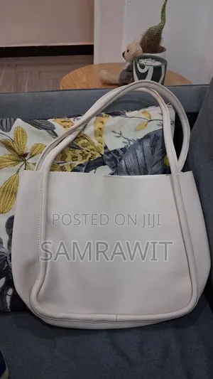 An Off-White Minimalist Shoulder Tote Bag.