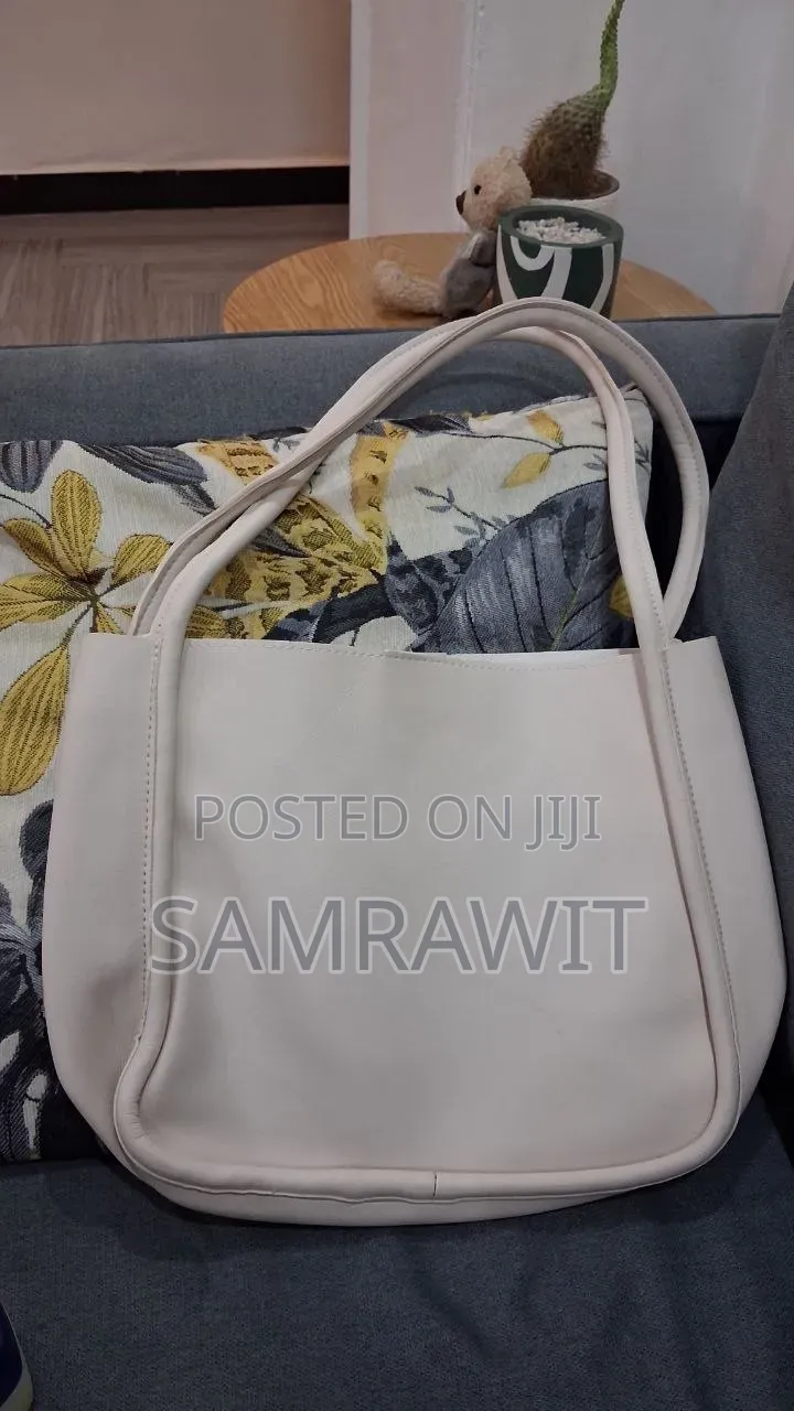 An Off-White Minimalist Shoulder Tote Bag.