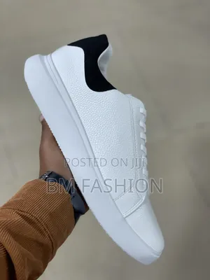 White Cole Haan Leather Sneaker With a Black Heel Tab