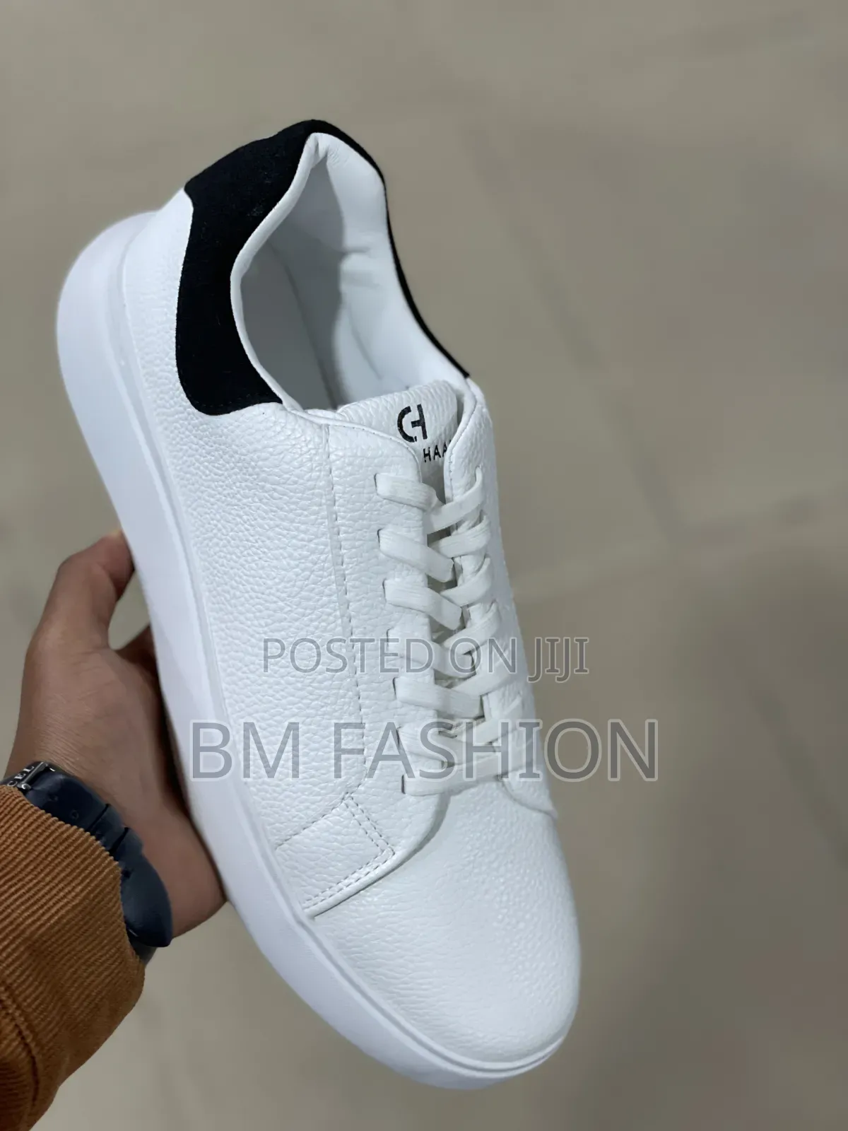 White Cole Haan Leather Sneaker With a Black Heel Tab
