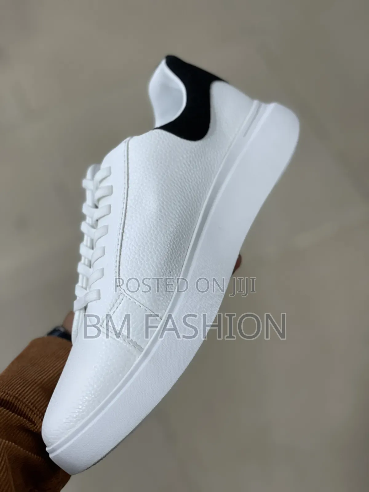 White Cole Haan Leather Sneaker With a Black Heel Tab