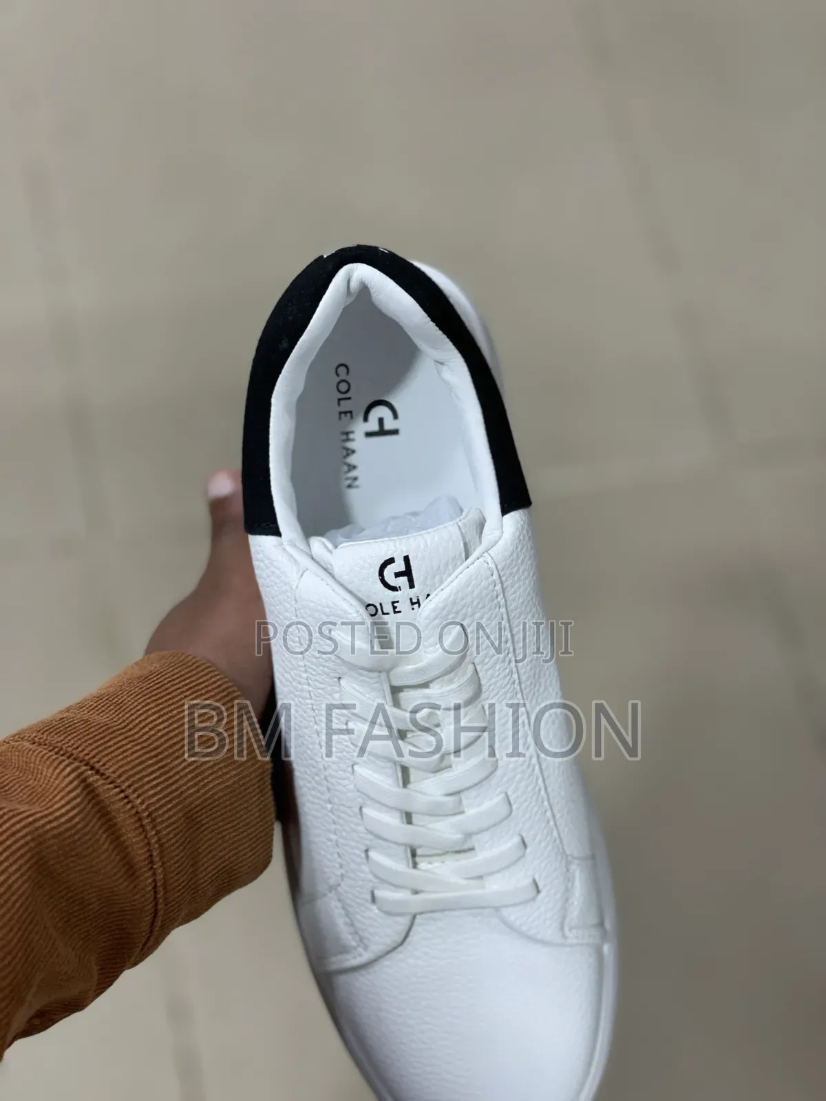 White Cole Haan Leather Sneaker With a Black Heel Tab