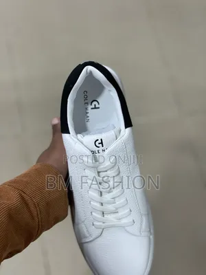 White Cole Haan Leather Sneaker With a Black Heel Tab