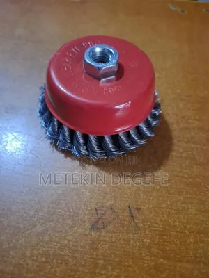 A Twisted Wire Cup Brush With a Red Protective Cover and Threaded