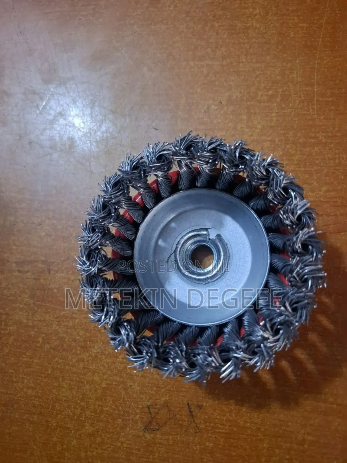 A Twisted Wire Cup Brush With a Red Protective Cover and Threaded