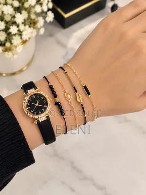 Gold-and-Black Women’s Watch With a Layered Bracelet Set.