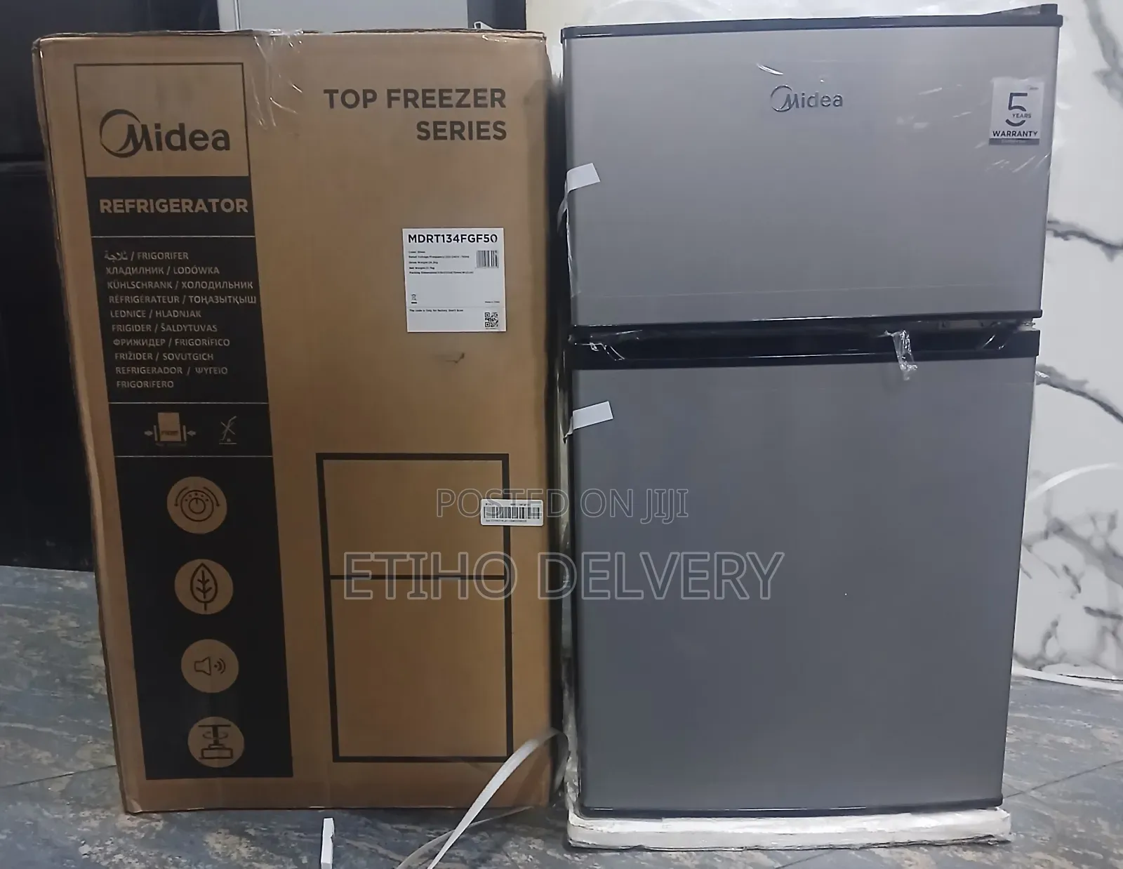 The Image Shows a Silver Midea Top Freezer Series Compact Refrigerator