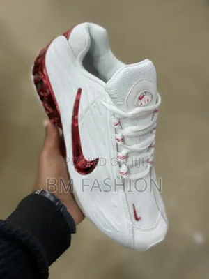 Nike Shoe Featuring a Metallic Red Swoosh and Matching Red Translucent