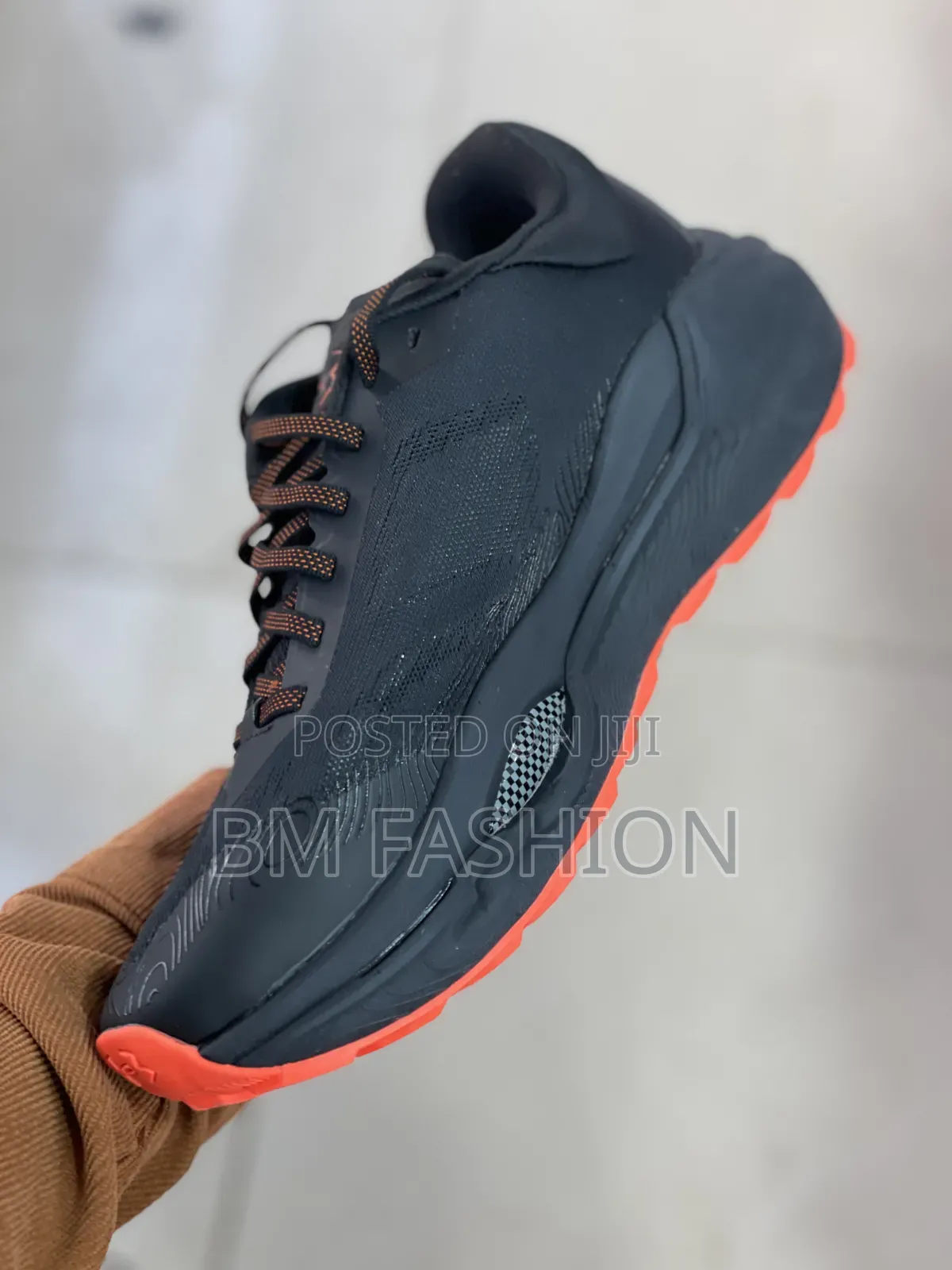 Under Armour Athletic Sneaker in Black With Bright Orange Accents
