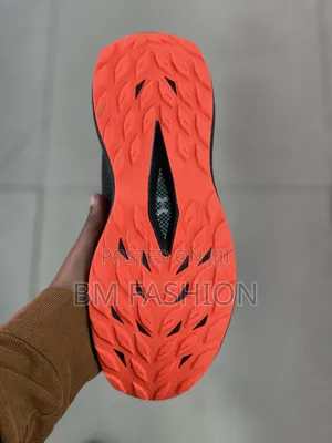 Under Armour Athletic Sneaker in Black With Bright Orange Accents