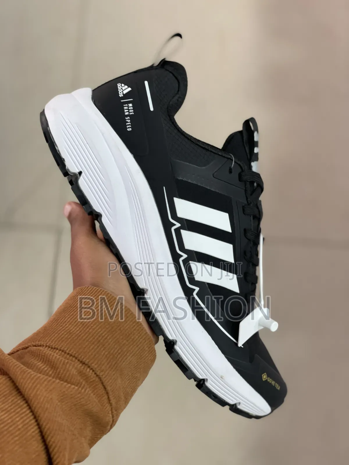 Black-and-White Adidas Athletic Sneaker Featuring Three-Stripe