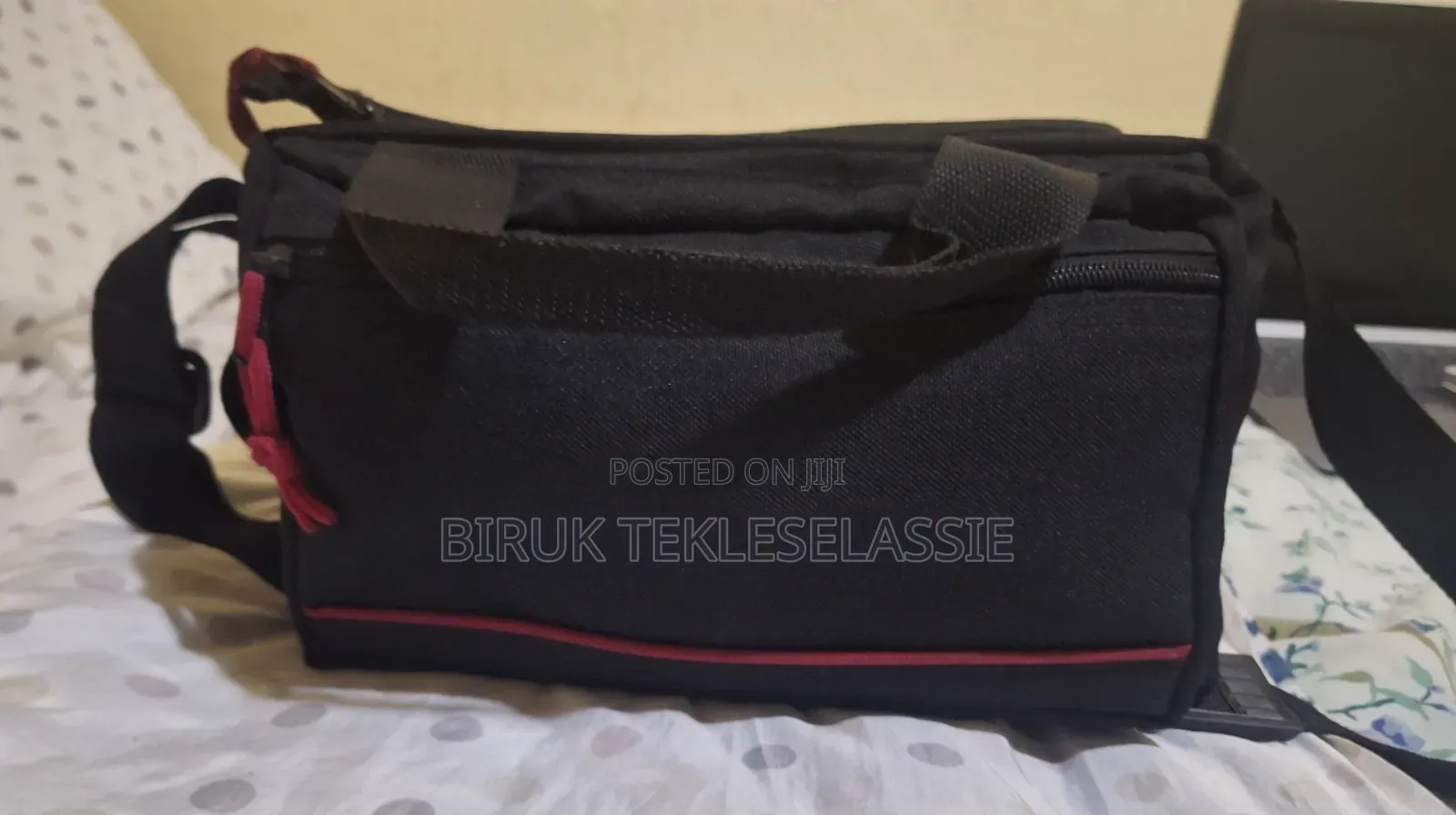 Used Camera Carrying Bag Case With an Adjustable Strap Buckle on Top