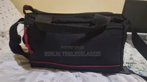 Used Camera Carrying Bag Case With an Adjustable Strap Buckle on Top