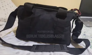 Used Camera Carrying Bag Case With an Adjustable Strap Buckle on Top