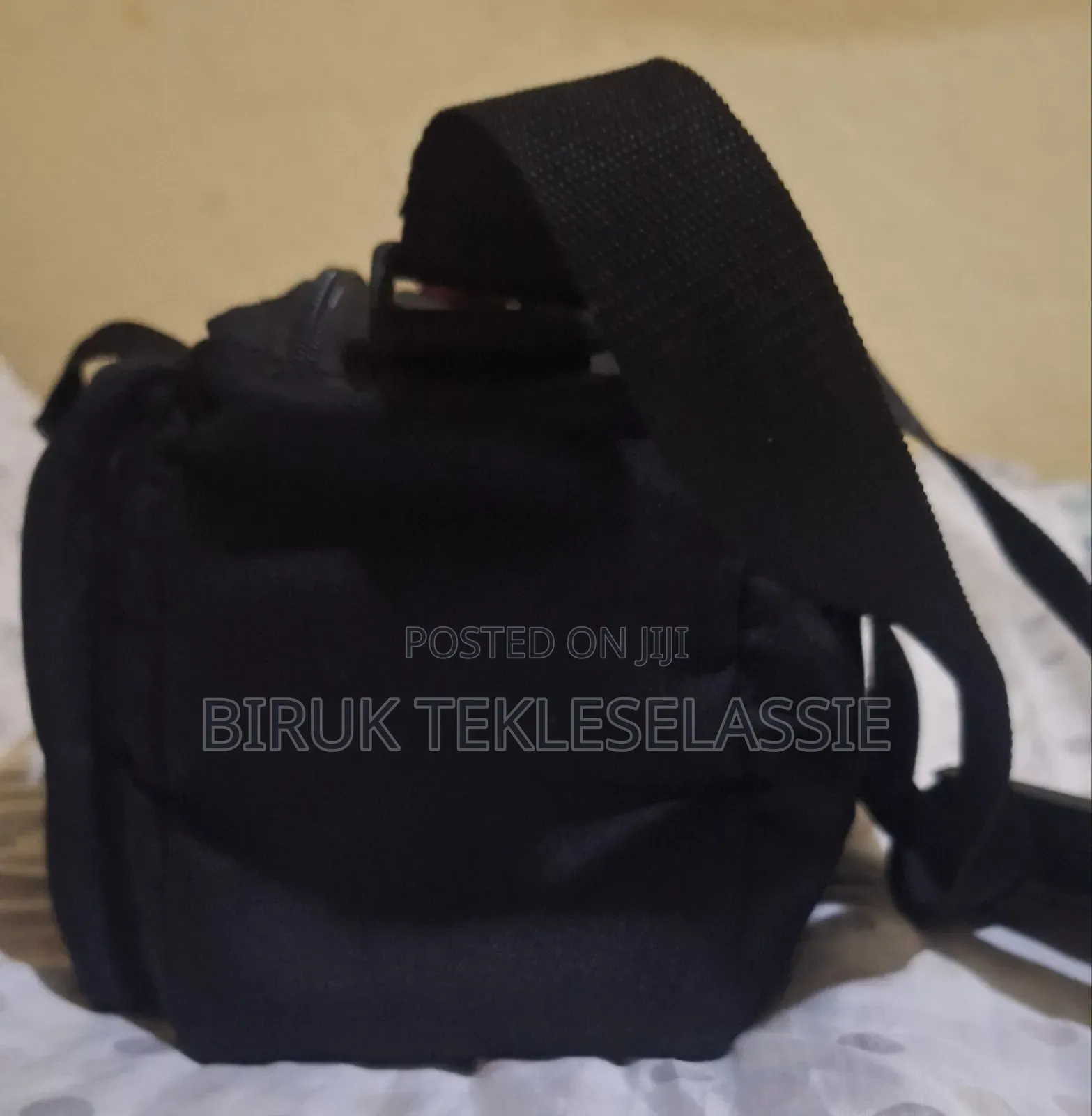 Used Camera Carrying Bag Case With an Adjustable Strap Buckle on Top