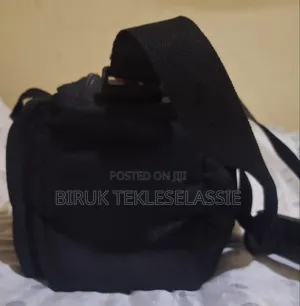 Used Camera Carrying Bag Case With an Adjustable Strap Buckle on Top
