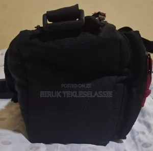 Used Camera Carrying Bag Case With an Adjustable Strap Buckle on Top