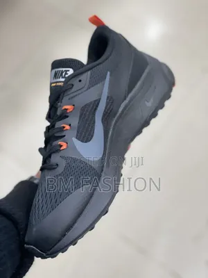 Nike Dark Performance Shoes With Orange Details and Grip Outsole