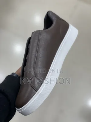 Sleek Brown Boss Casual Sneaker Featuring a Textured Leather Upper