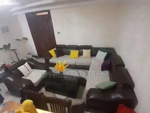 L-Shaped Sofa Set With Centered Table and Cushions and Center Table