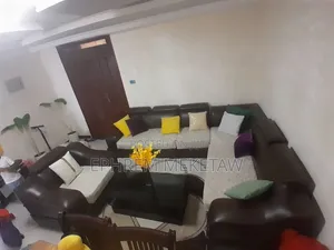 L-Shaped Sofa Set With Centered Table and Cushions and Center Table