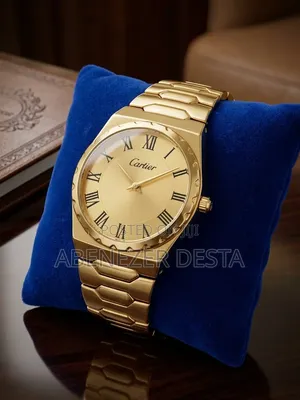 Gold-Colored Analog Wristwatch Branded With the Cartier Logo