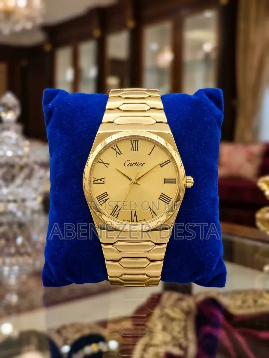 Gold-Colored Analog Wristwatch Branded With the Cartier Logo