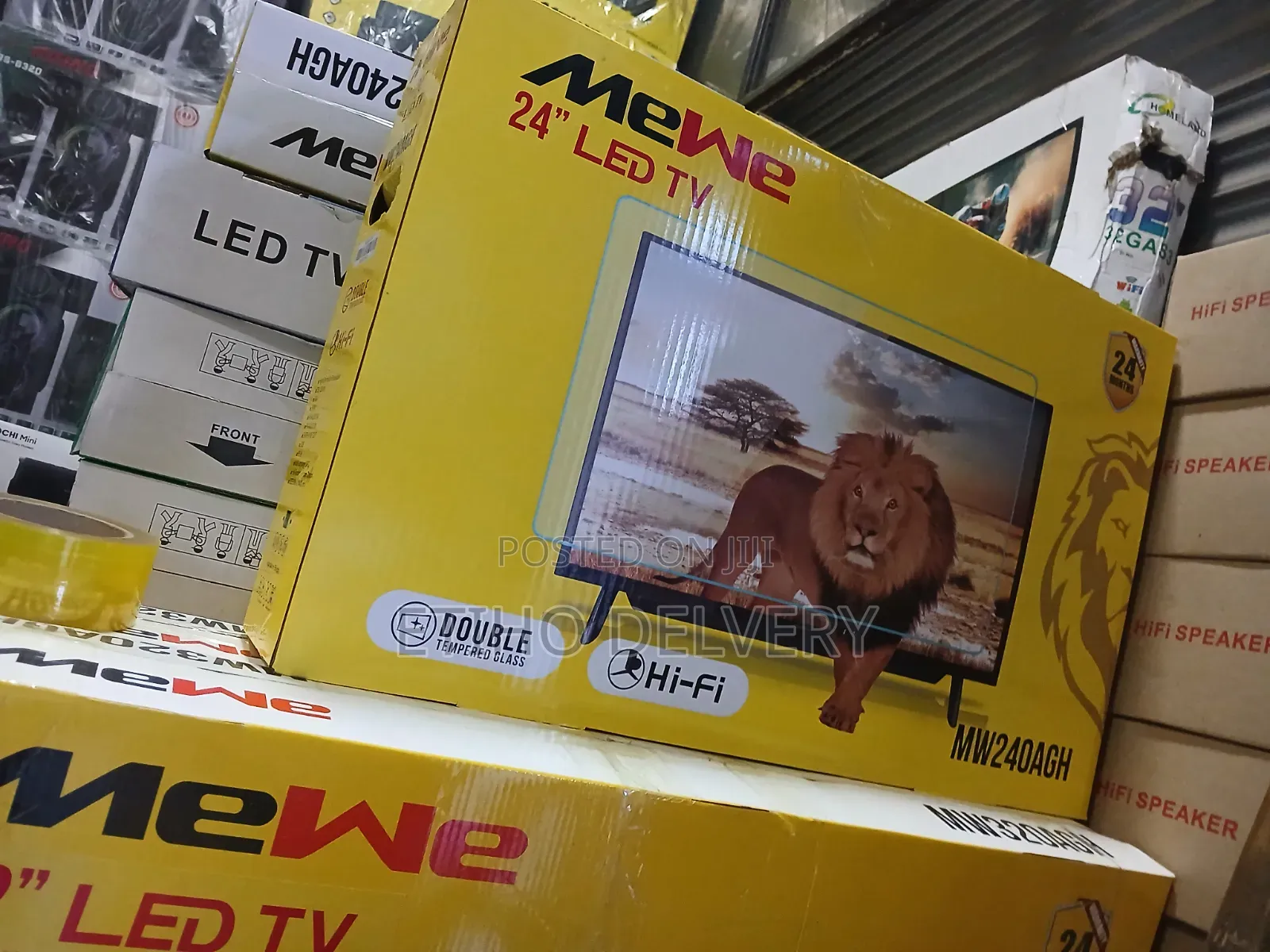 The Image Shows a Box for a MeWe 32-Inch LED TV With a Double Glass Sc