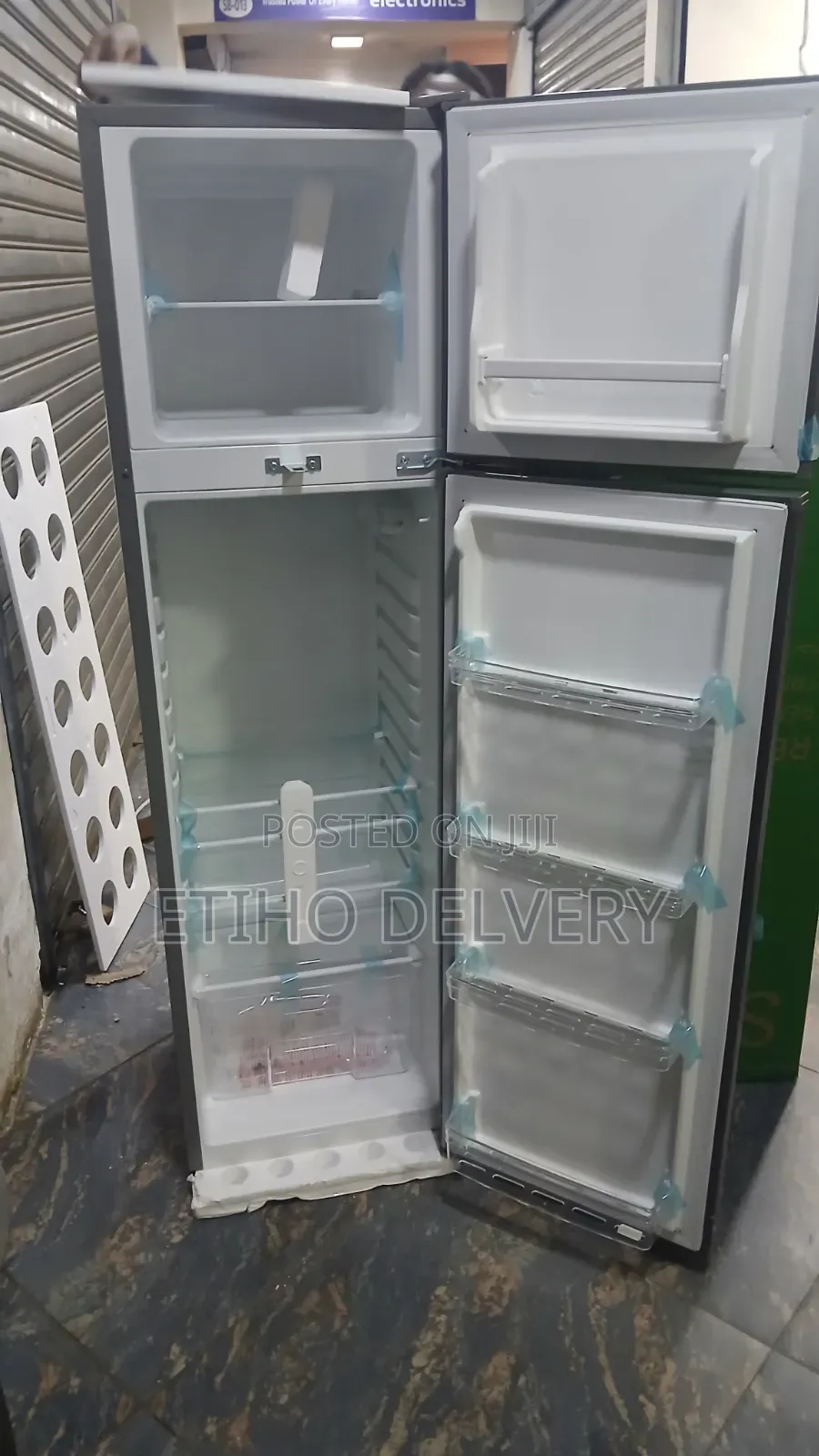 The Image Shows a Silver, Two-Door (Top-Freezer) Compact or Mid-S