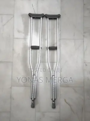Photo - Auxiliary Crutch Pair to Patient Post-Surgery/Injury in Legs