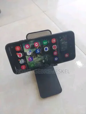 The Image Shows a White Folding Desktop Phone Stand
