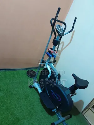 Photo - Exercise Bike With a Set of Dumbbell