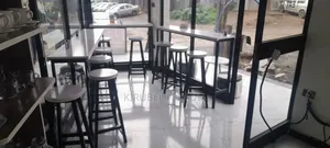 Photo - Cafe Bar and Chairs With Their Tables