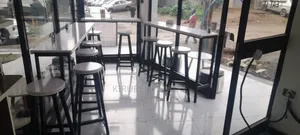 Cafe Bar and Chairs With Their Tables