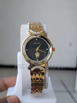 Photo - Gold-Toned Women's Watch With a Black Face and Crystal Accents.