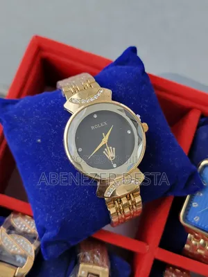 Gold-Toned Women's Watch With a Black Face and Crystal Accents.