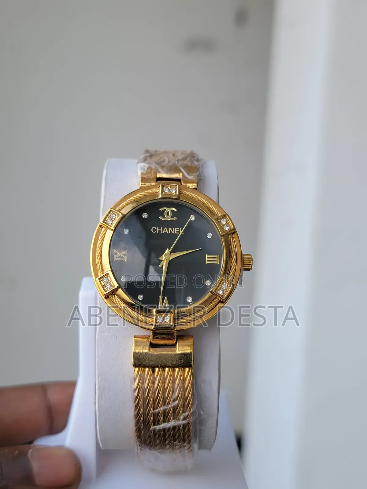 Chanel Watch With a Gold-Toned Case and Band, a Black Dial