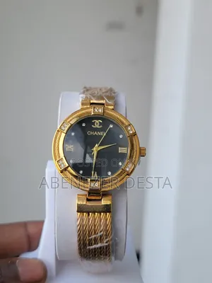 Photo - Chanel Watch With a Gold-Toned Case and Band, a Black Dial