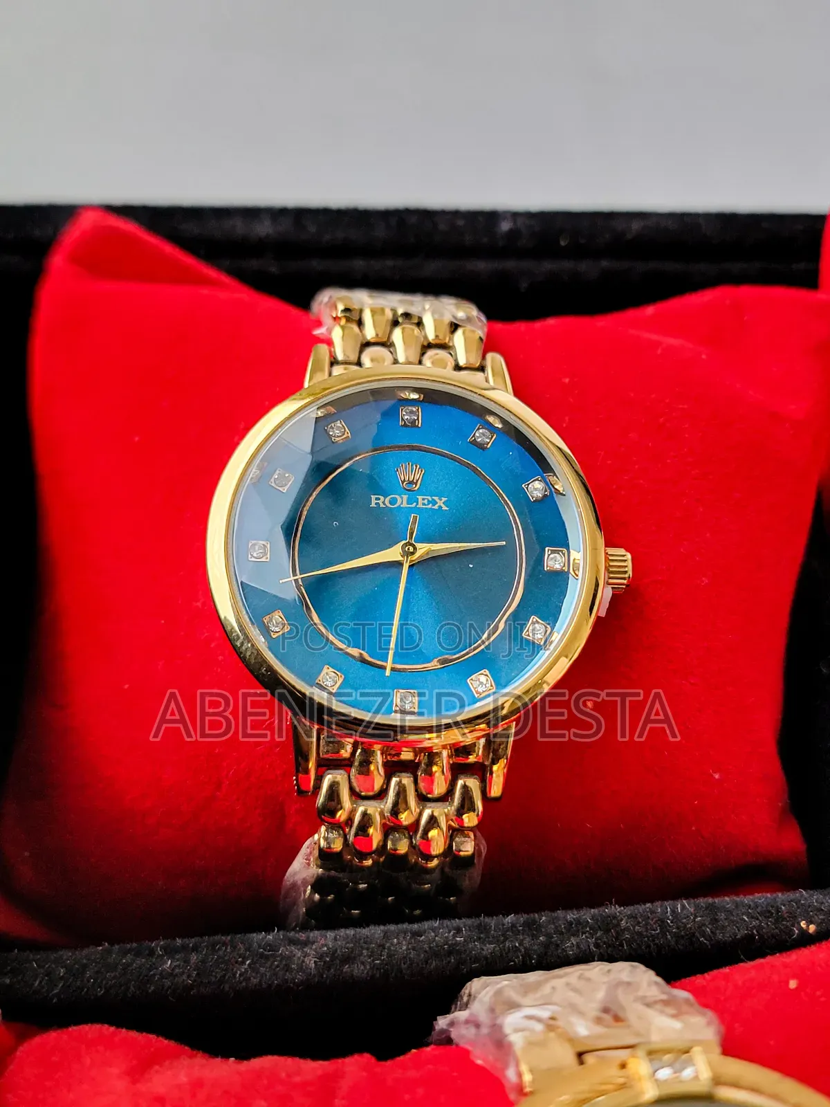 Gold-Toned Rolex Watch With a Blue Dial and Diamond Hour Markers.