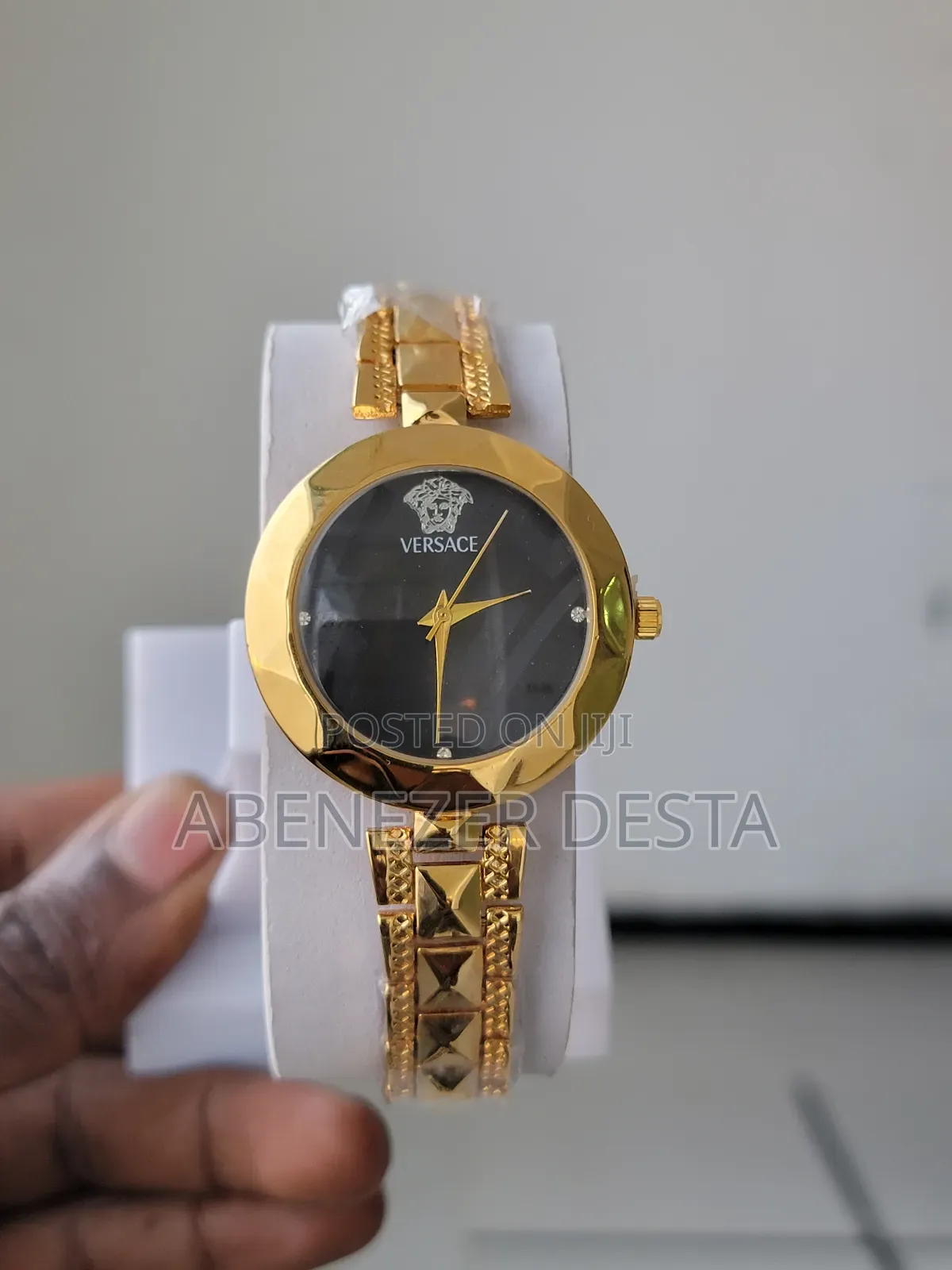 Versace Gold-Tone Watch With a Black Dial and a Medusa Head Logo.