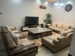 Photo - A Unique Sofa Complemented by a Ceramic Table Is a Statement Piece.