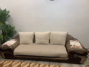 A Unique Sofa Complemented by a Ceramic Table Is a Statement Piece.