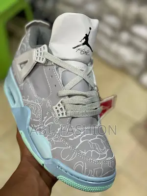 Photo - Air Jordan 4 Retro Kaws Sneakers in Cool Grey.