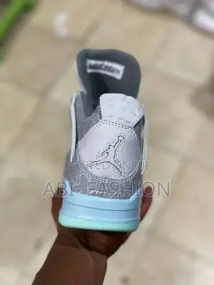 Air Jordan 4 Retro Kaws Sneakers in Cool Grey.