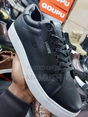 Photo - This Is Apair of Black Lacoste Leather Snickers With a White Sole