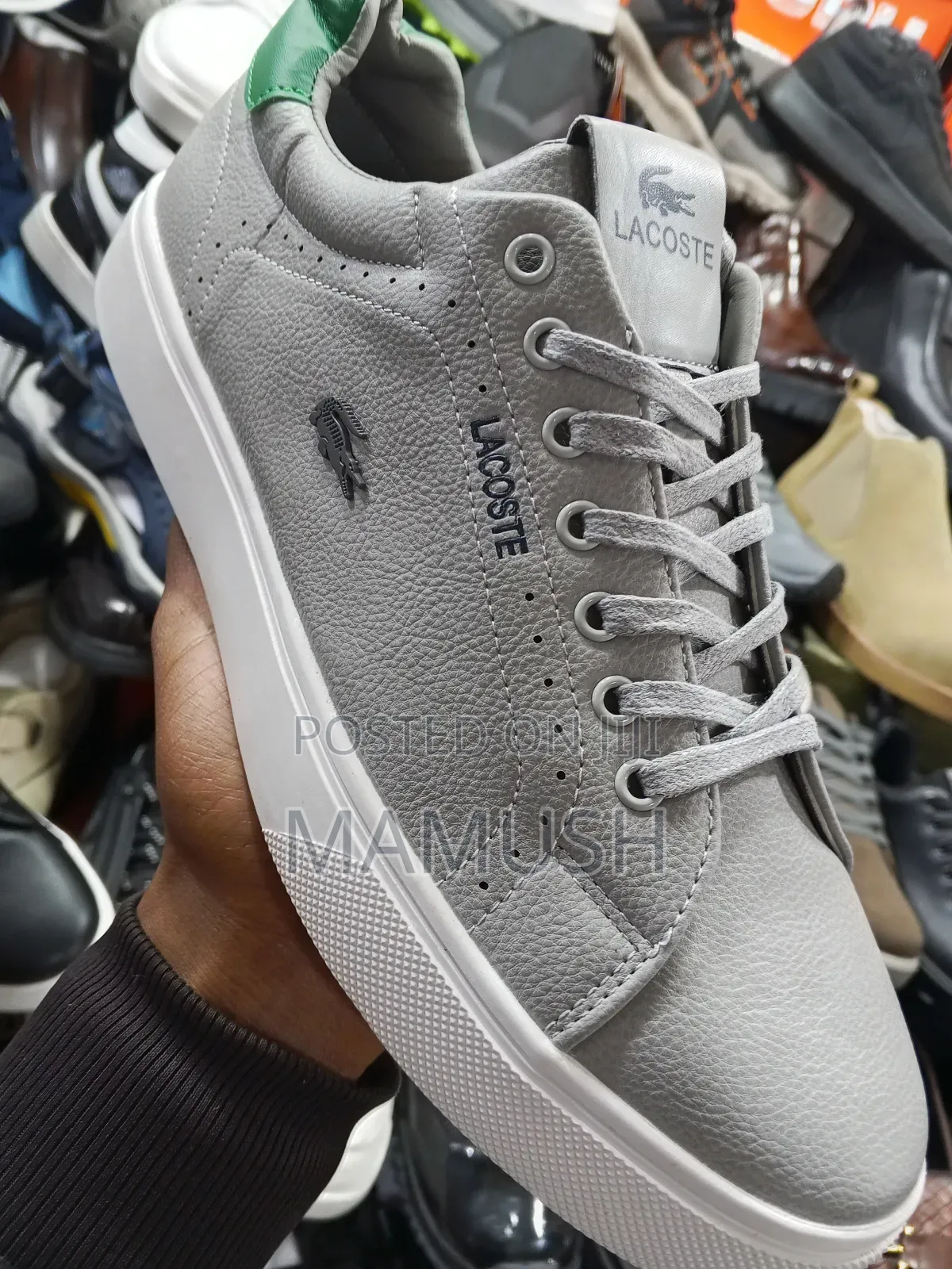 This Is Apair of Black Lacoste Leather Snickers With a White Sole