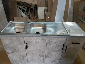 Photo - Kitchen Sink Cabinet With a Double Stainless-Steel Basin and Drainer.