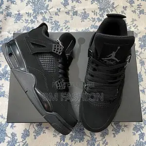Photo - Air Jordan 4 Retro Sneakers in a Black and Light Graphite Colorway