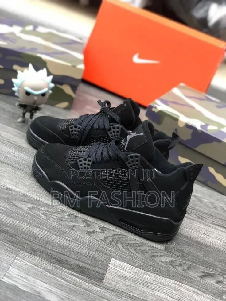 Air Jordan 4 Retro Sneakers in a Black and Light Graphite Colorway